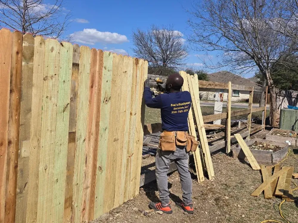 Wood privacy fence installation by Sua's Handyman Services