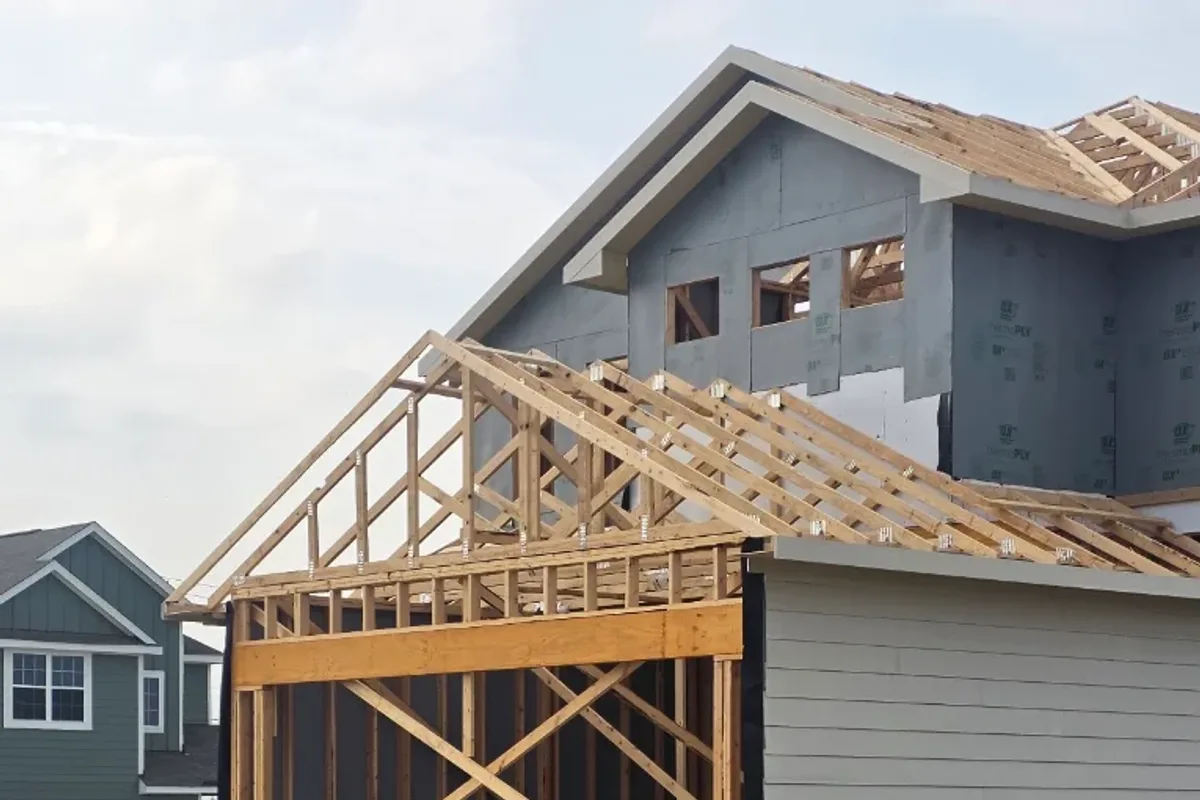 Carpenter measuring and cutting trim