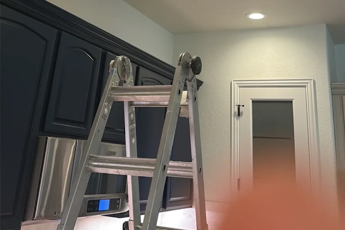 Electrician installing a light fixture