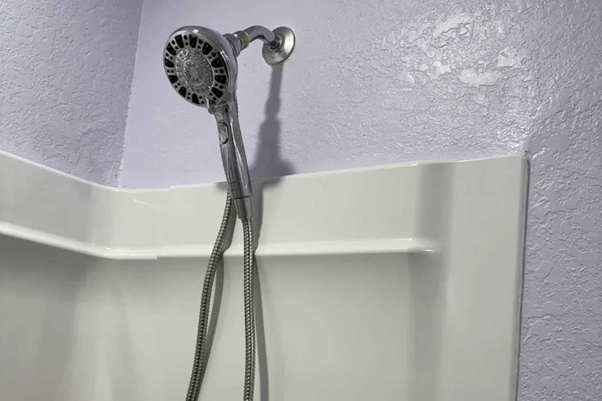 Handyman repairing plumbing under a sink